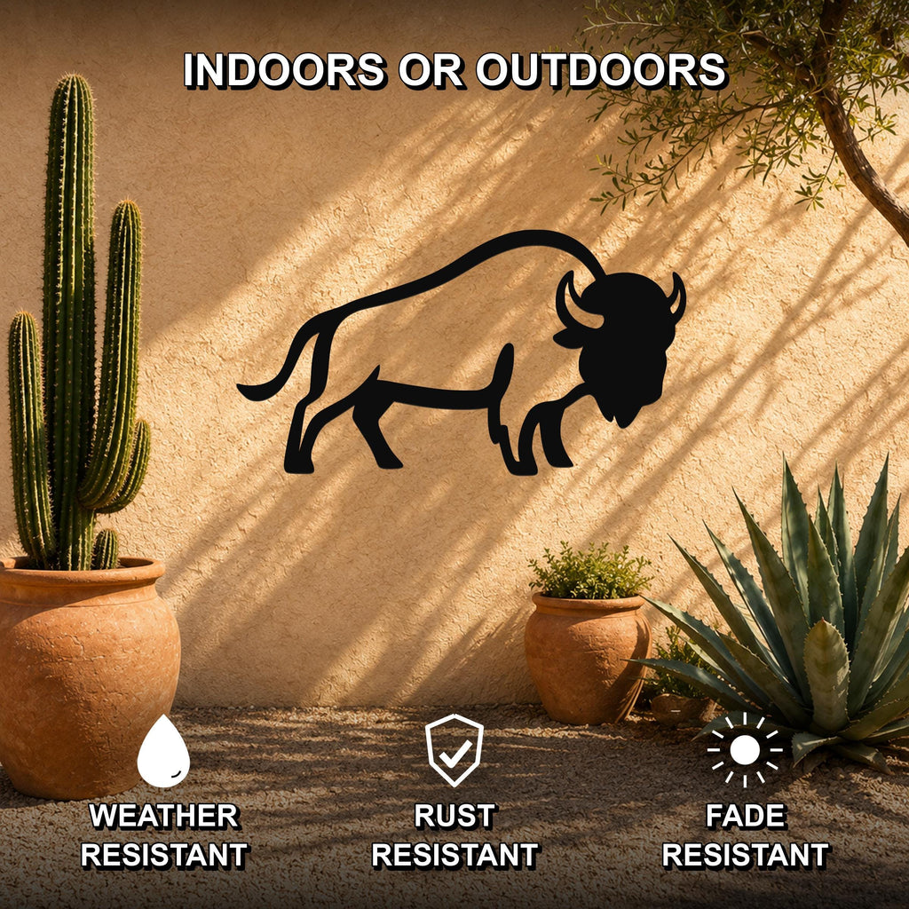 Black metal buffalo silhouette wall art mounted on a stucco outdoor wall, surrounded by potted cacti and succulents, with text indicating it is weather, rust, and fade resistant for indoor or outdoor use.