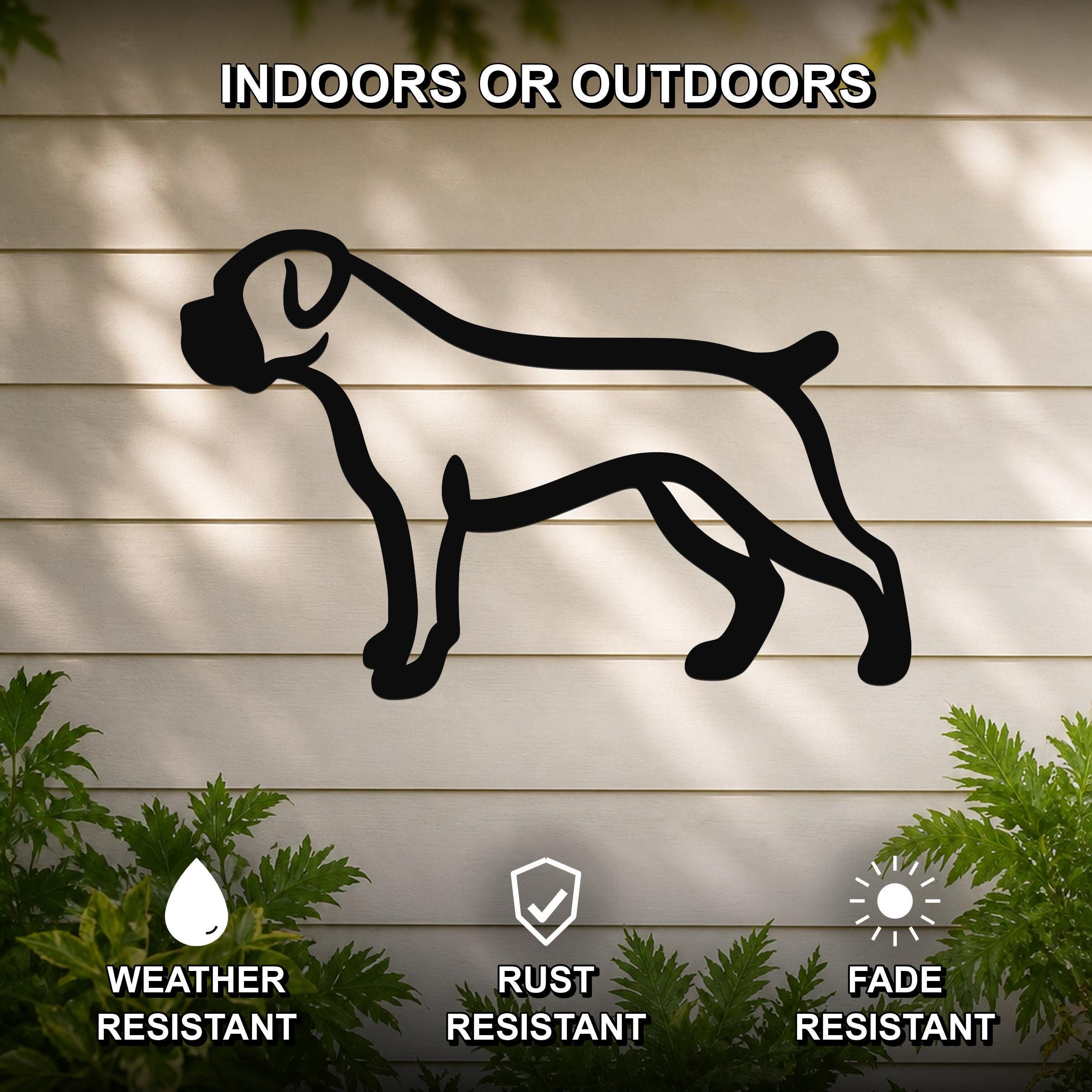 Black metal Boxer dog silhouette wall art mounted on a light-colored outdoor wall, with green plants at the base and text indicating it is weather, rust, and fade resistant.