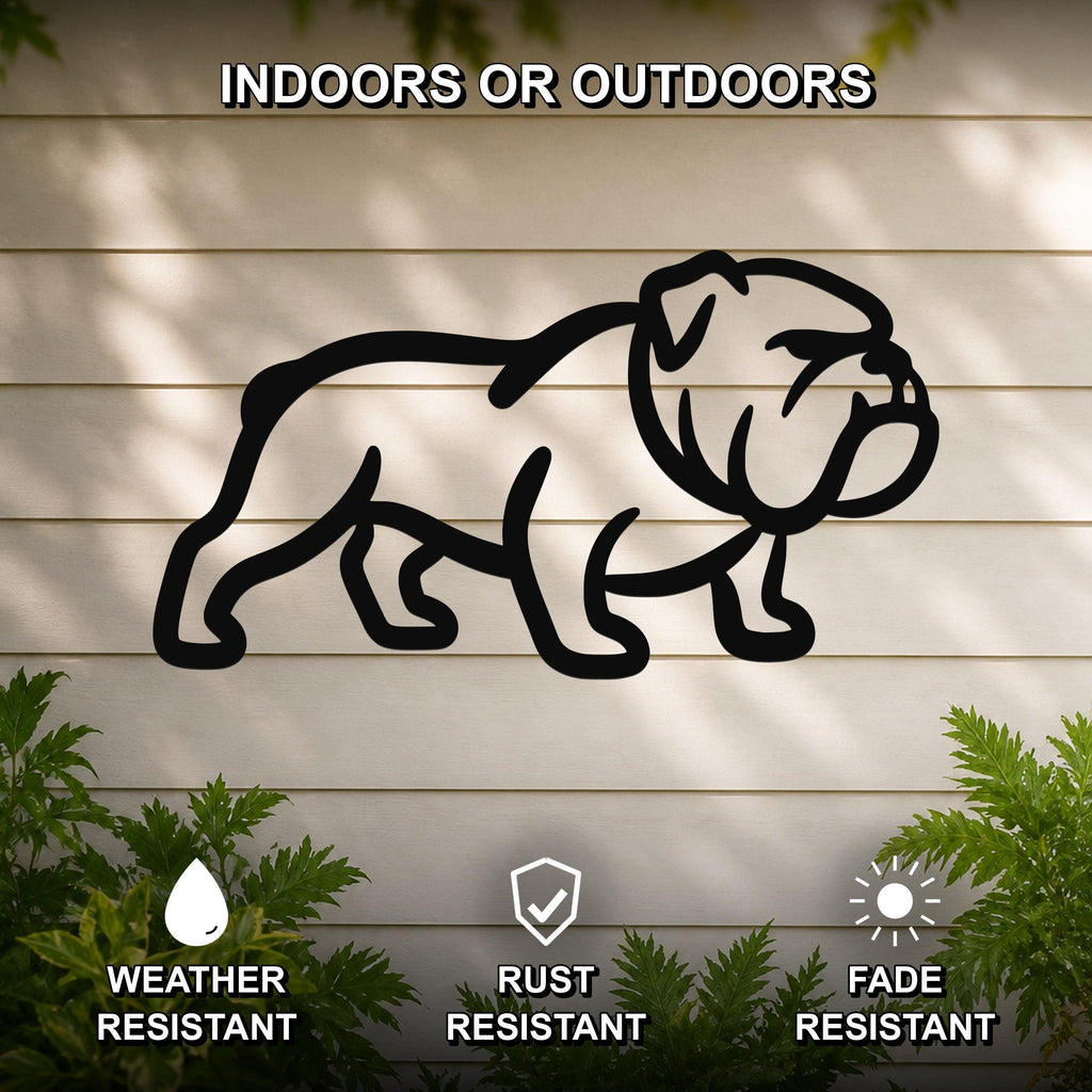 Black metal bulldog wall art silhouette mounted on a light-colored outdoor wall, with green plants at the base and text indicating it is weather, rust, and fade resistant.