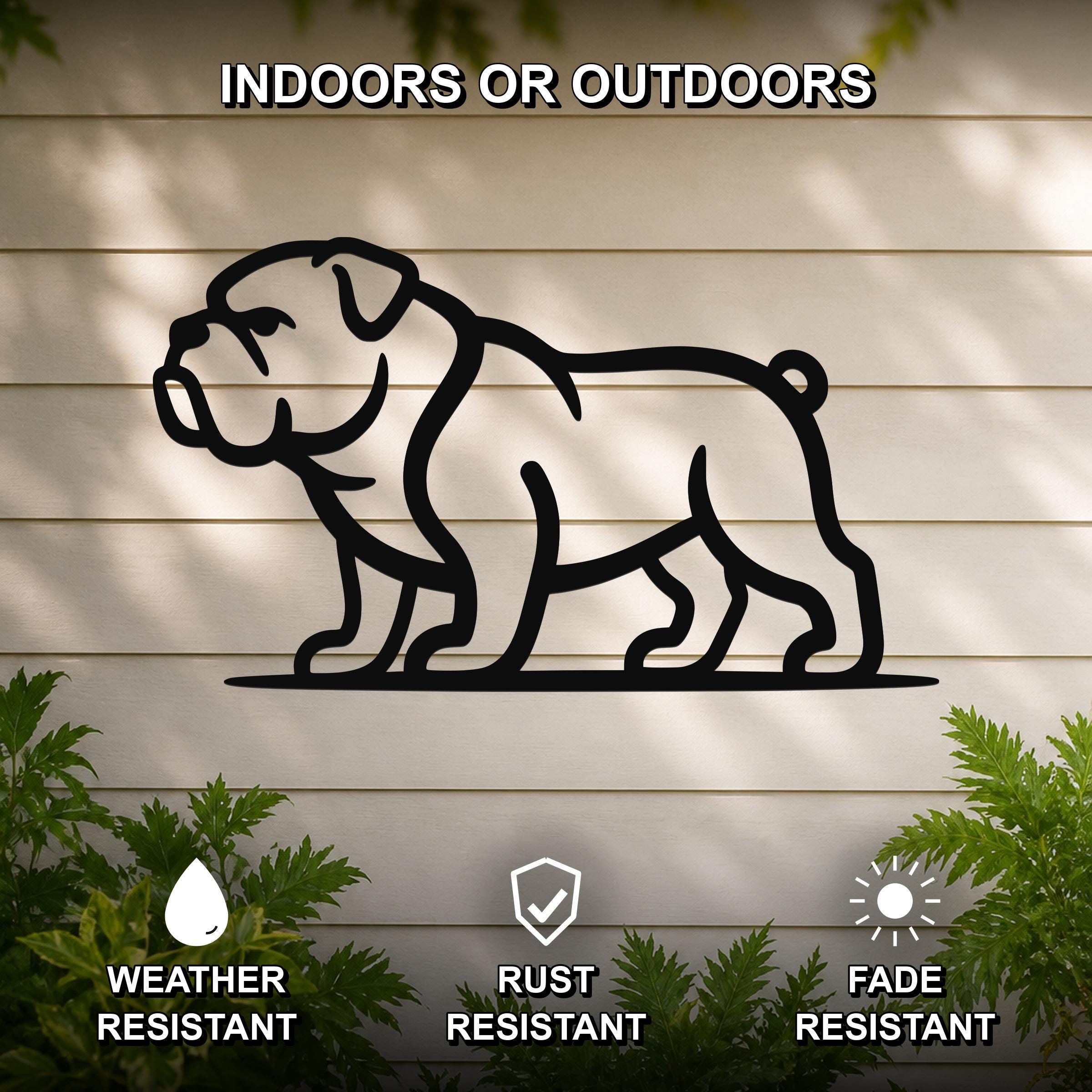 Black metal bulldog silhouette wall art mounted on a light-colored outdoor wall, with green plants at the base and text indicating it is weather, rust, and fade resistant.