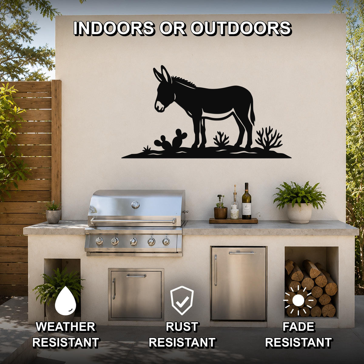 Black metal burro wall art silhouette with cactus cutouts, mounted on an outdoor patio wall above a stainless steel grill and counter.