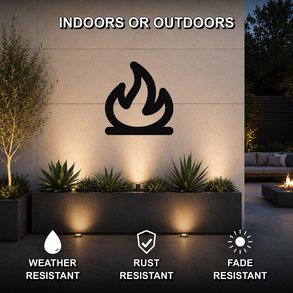 Black metal campfire silhouette wall art mounted on an outdoor wall above a planter, with warm lighting and visible weather, rust, and fade resistance icons.