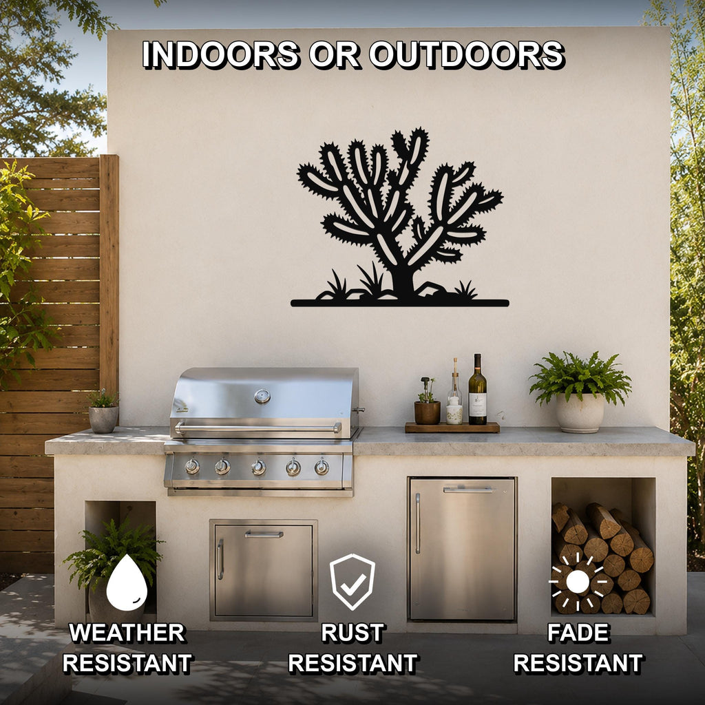 Black metal Cholla cactus wall art with spiky branch cutouts, mounted on a beige outdoor wall above a kitchen counter.