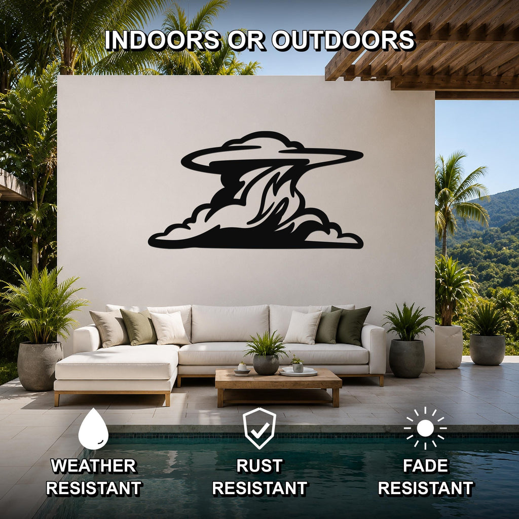 Black metal cloud wall art with flowing silhouette cutouts, mounted on a white outdoor wall above a sofa in a patio living area.