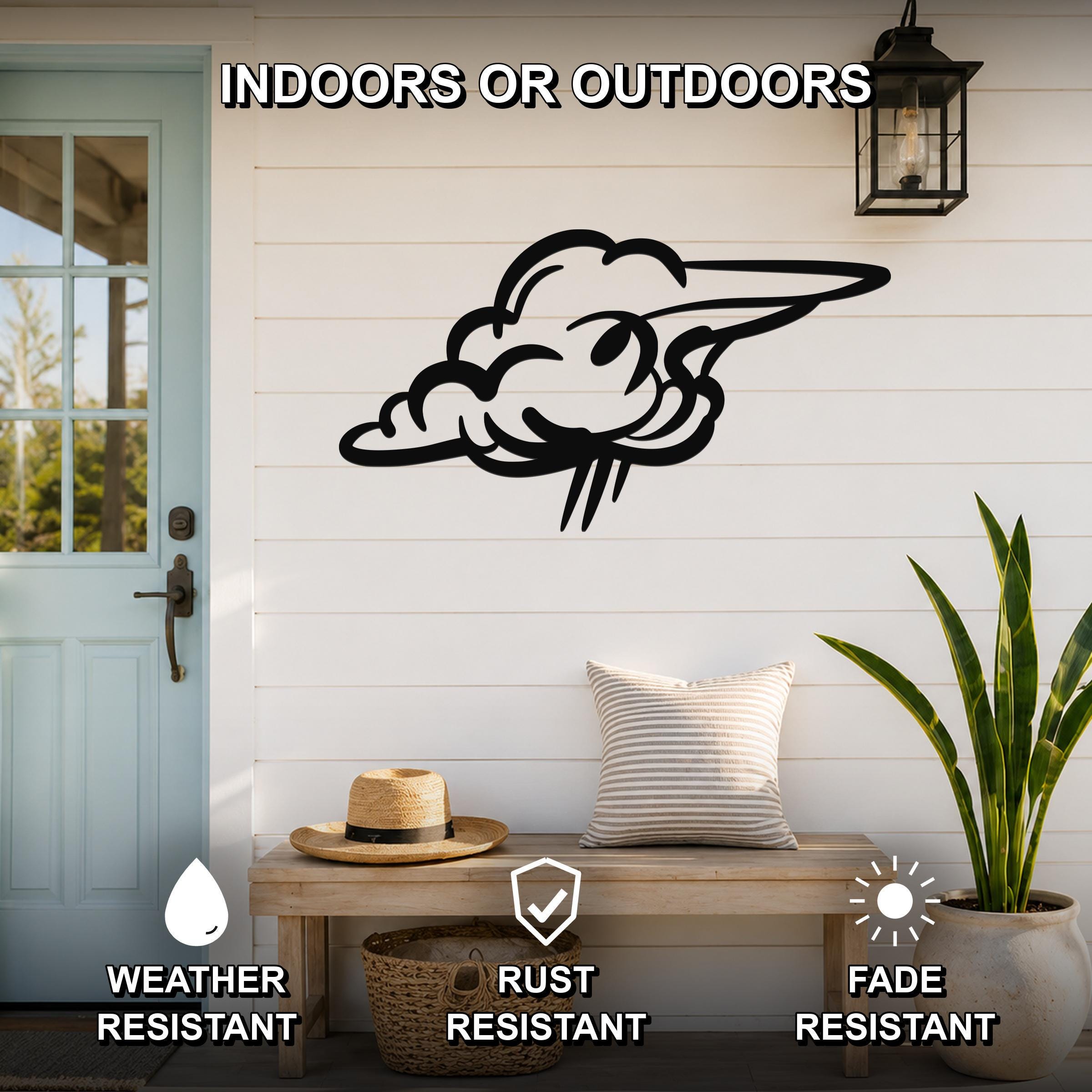 Black metal cloud wall art with motion-line cutouts, mounted on a white shiplap wall above a wooden bench on a porch.
