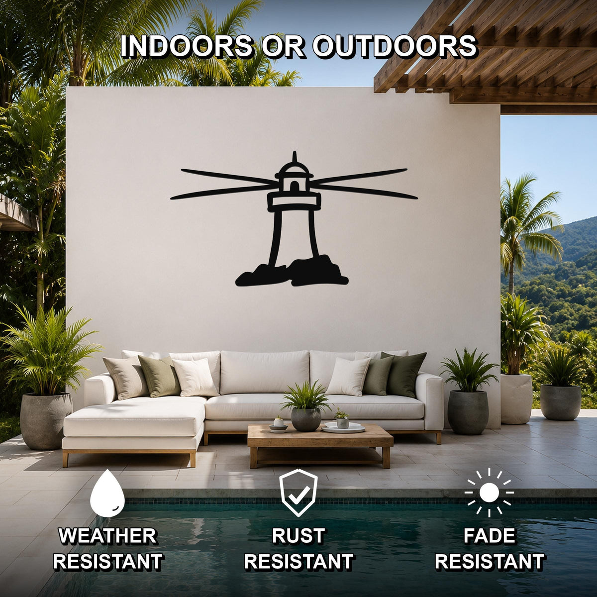 Black metal lighthouse wall art with horizontal ray cutouts, mounted on a white outdoor wall above a sofa in a patio living area.