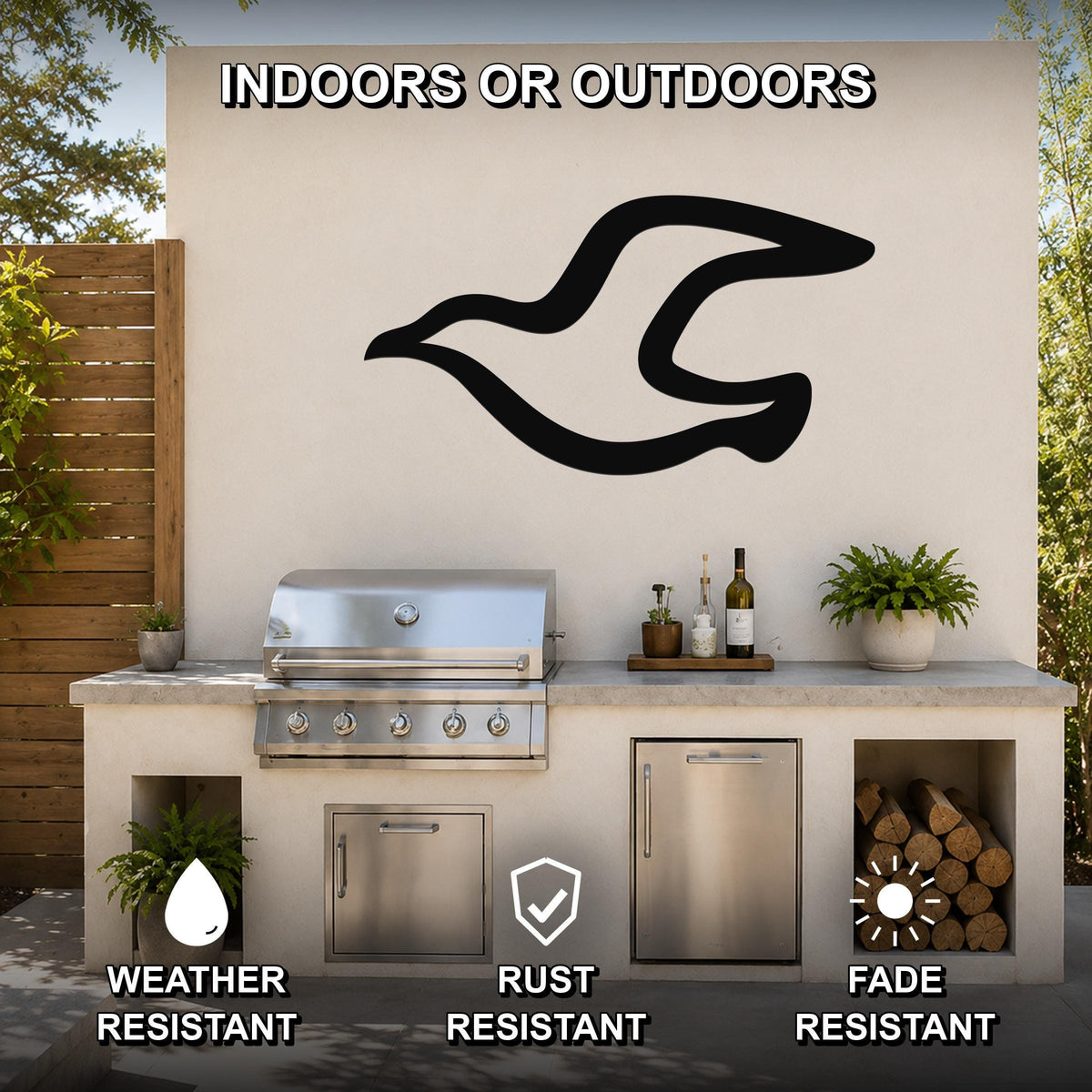 Black metal seagull wall art with motion-line cutouts, mounted on an outdoor patio wall above a grill and counter.