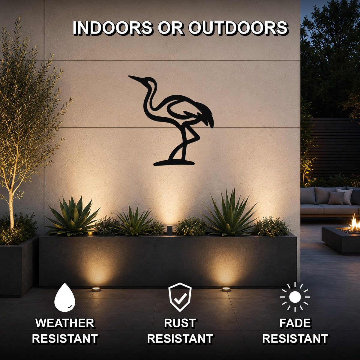 Black metal crane wall art silhouette mounted on an outdoor wall above a planter, with text indicating it is weather, rust, and fade resistant.