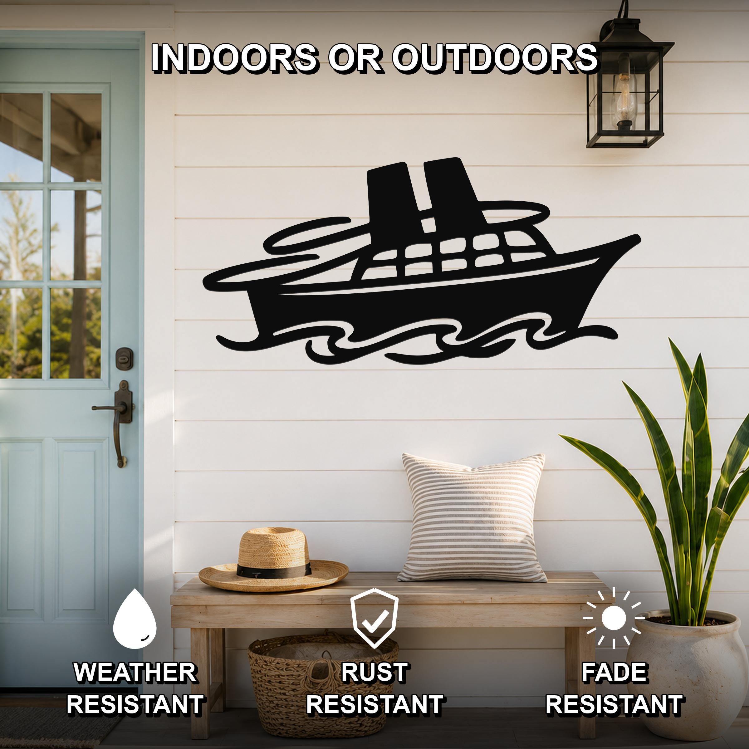 Black metal cruise ship wall art with wave cutouts, mounted on a white shiplap wall above a wooden bench in a porch setting.