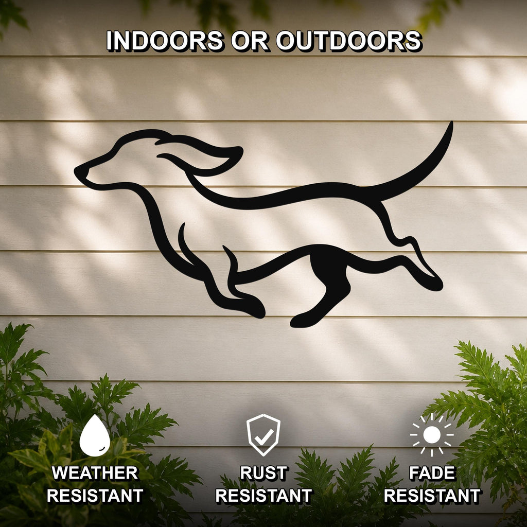 Black metal dachshund wall art with bold silhouette lines, mounted on a light-colored outdoor wall with greenery, weather resistant, rust resistant, and fade resistant.