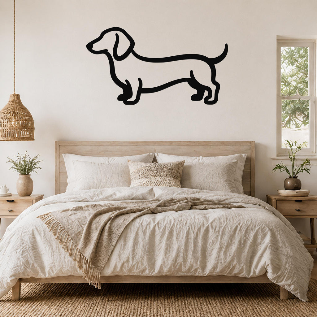 Black metal dachshund wall sculpture in silhouette style, mounted above a wooden bed in a neutral bedroom.