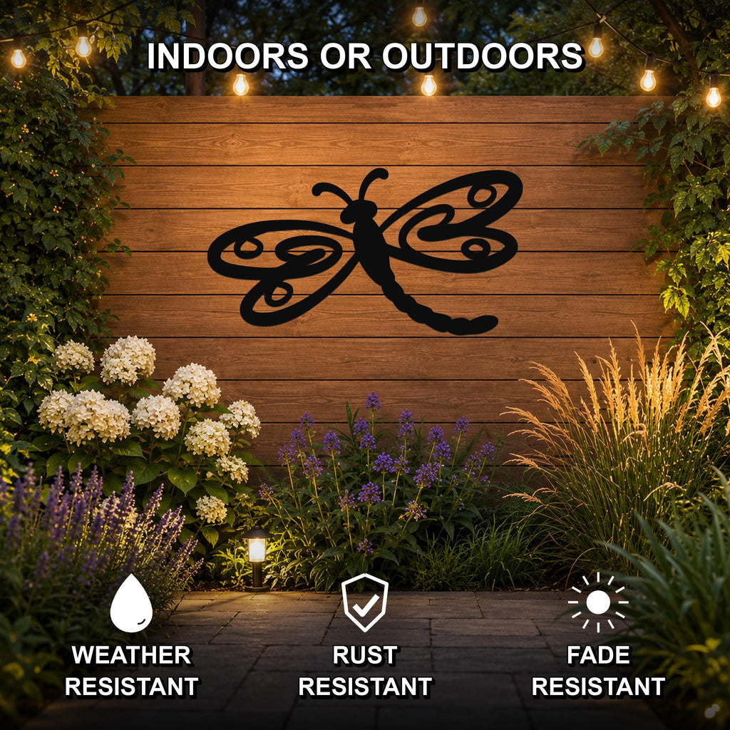Black metal dragonfly wall art with intricate wing cutouts, mounted on a wooden outdoor wall surrounded by plants and string lights.