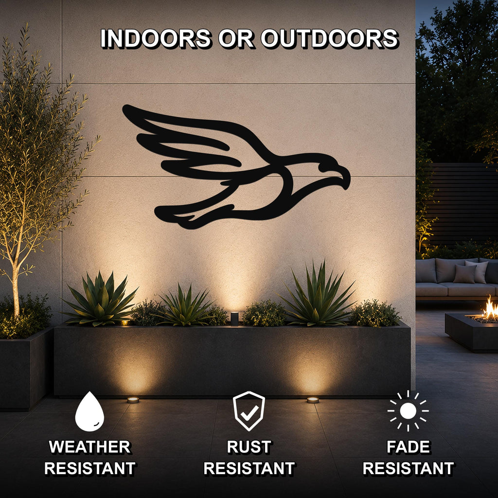 Black metal eagle wall art with a bold silhouette and wing cutouts, mounted on an outdoor wall above a planter in a modern patio setting.