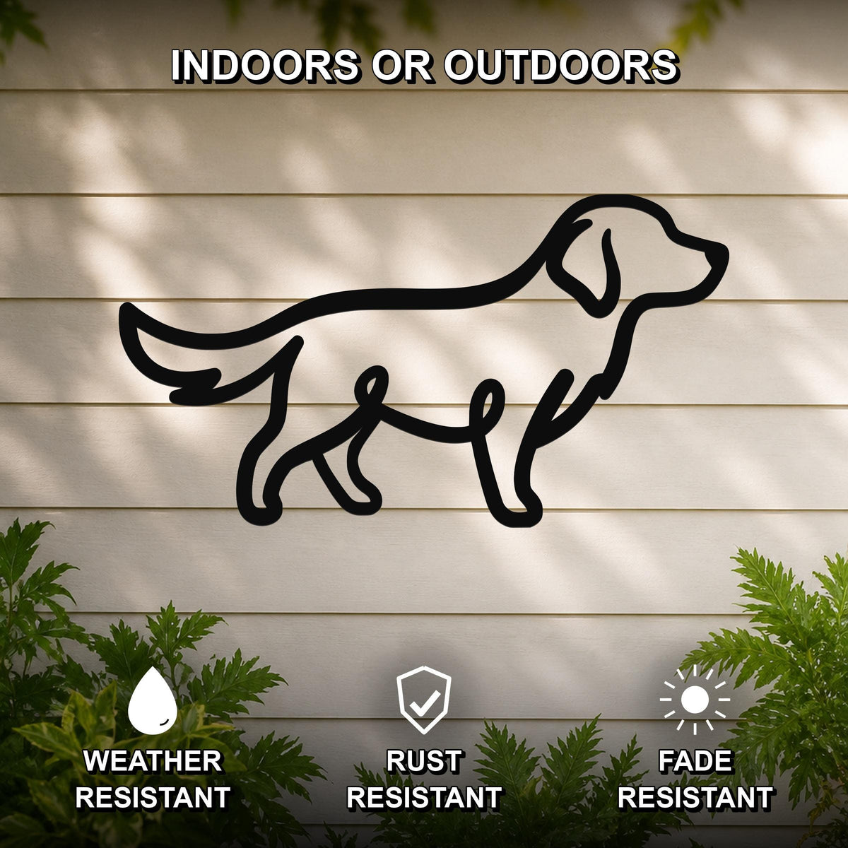 Black metal dog silhouette wall art mounted on a light-colored outdoor wall, with green plants at the base and text indicating it is weather, rust, and fade resistant.