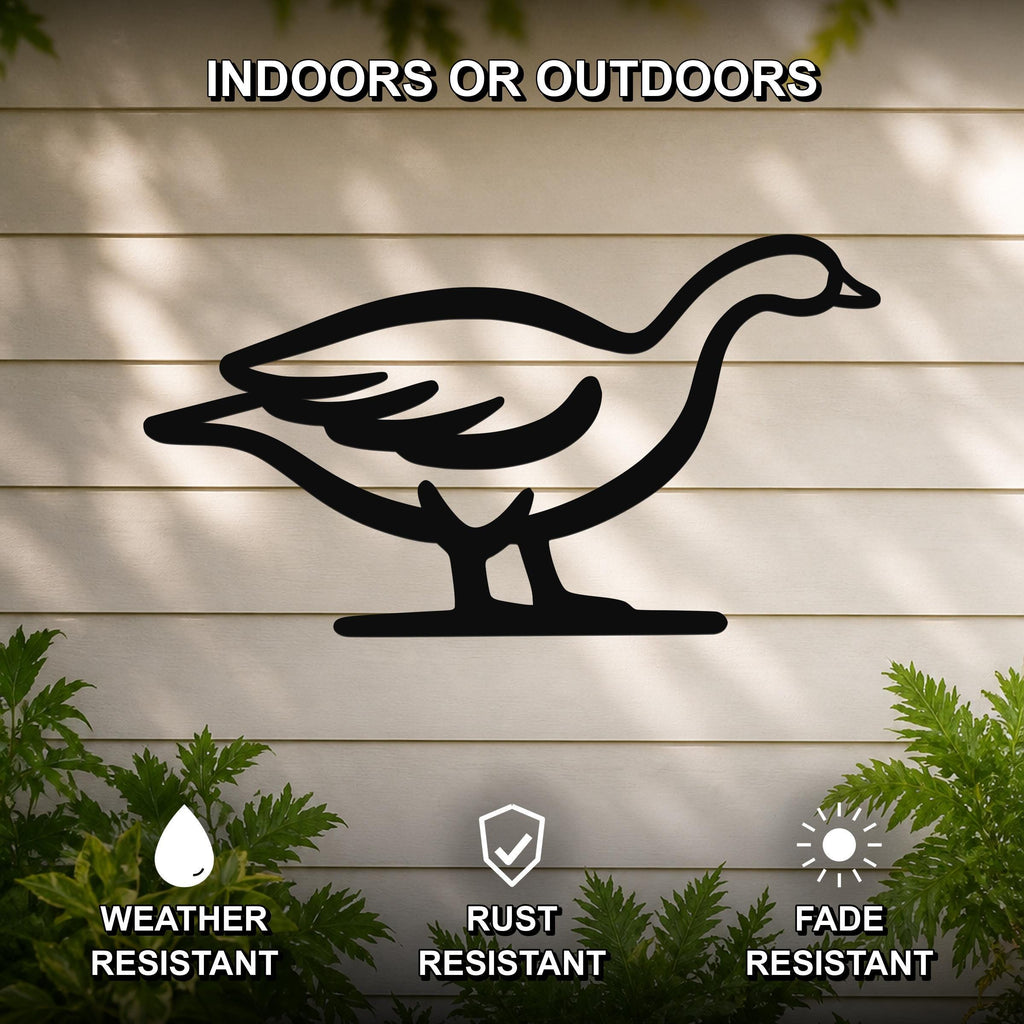 Black metal goose silhouette wall art with internal cutout details, mounted on a light-colored outdoor wall with greenery, weather resistant, rust resistant, and fade resistant.