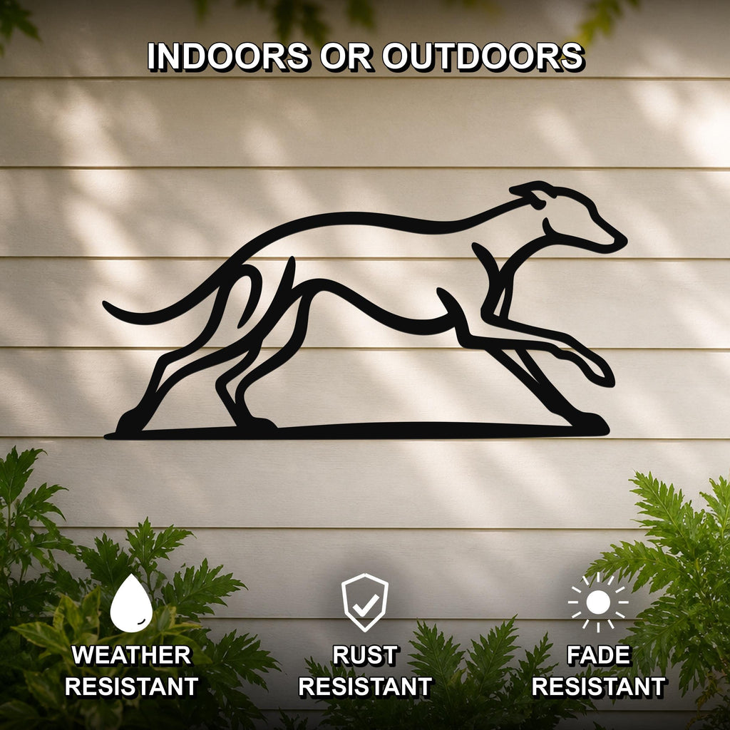 Black metal greyhound wall art with a minimalist silhouette design, mounted on a light-colored outdoor wall with greenery below.