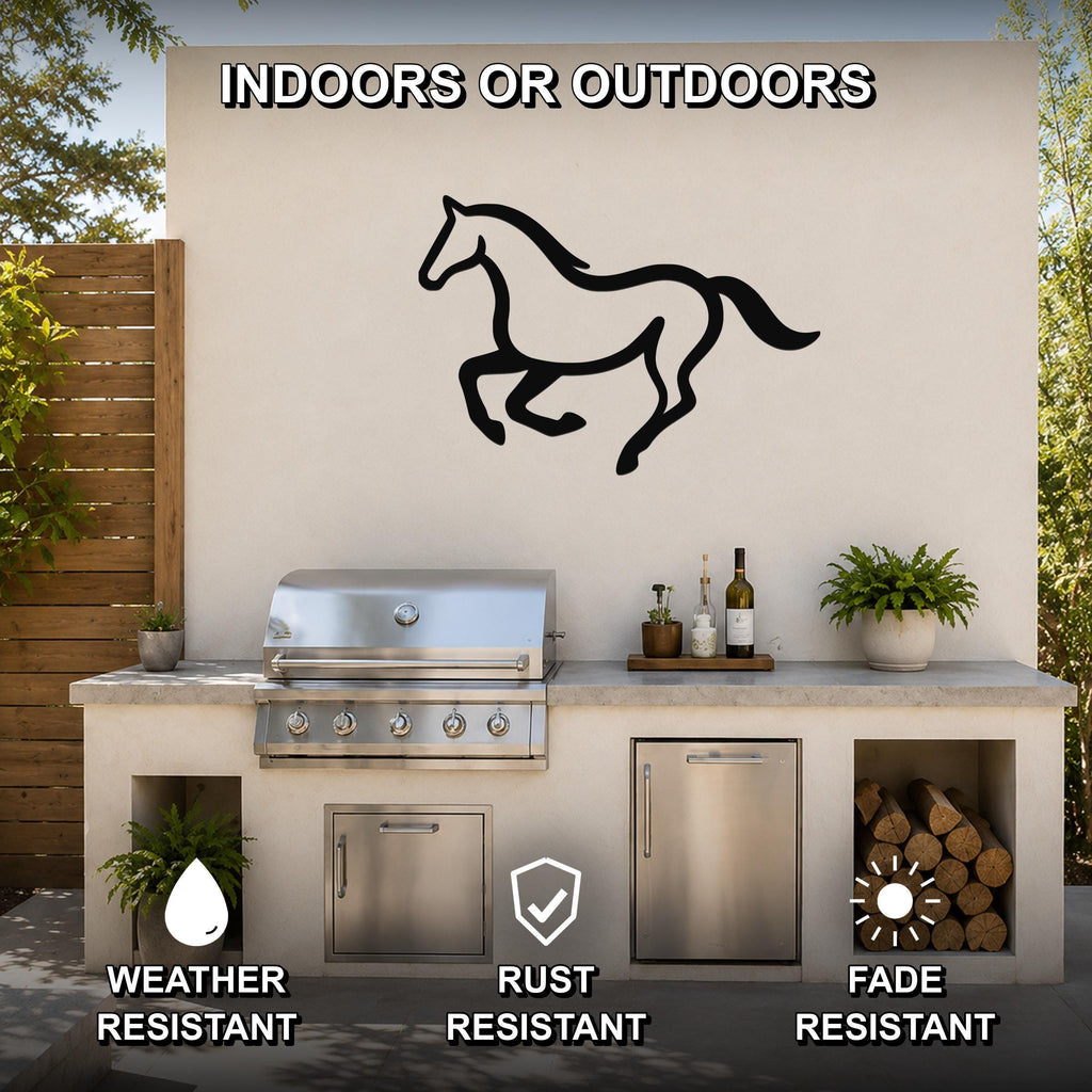 Black metal horse wall art in a running silhouette, mounted on an outdoor patio wall above a stainless steel grill and counter.