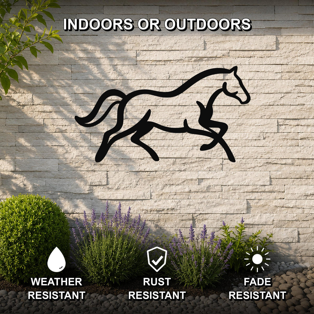 Black metal horse wall art silhouette with motion-line cutouts, mounted on a light stone outdoor wall above a garden bed with lavender and pebbles.