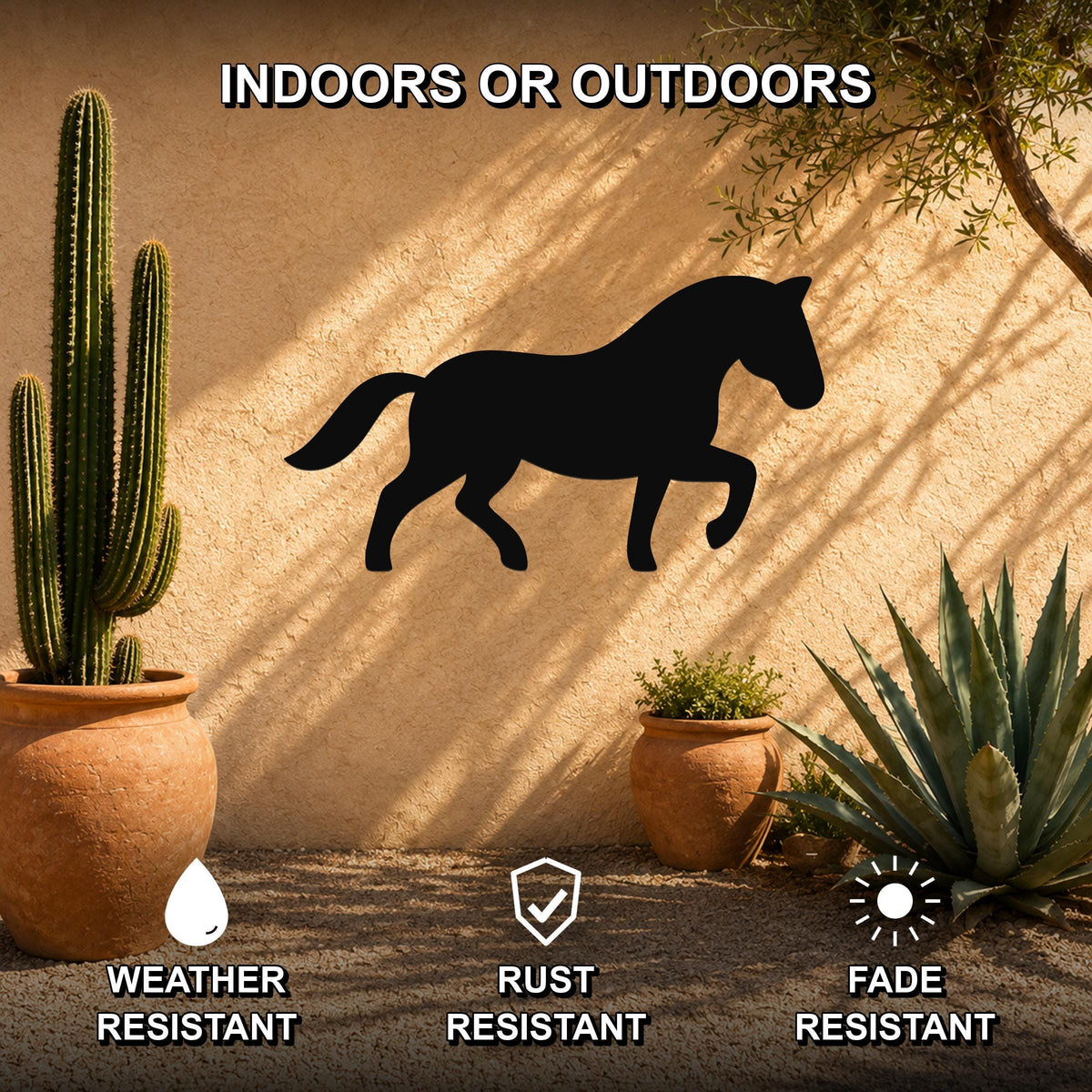 Black metal horse silhouette wall art mounted on an outdoor stucco wall, displayed with potted cacti and succulents in a desert-style patio setting.