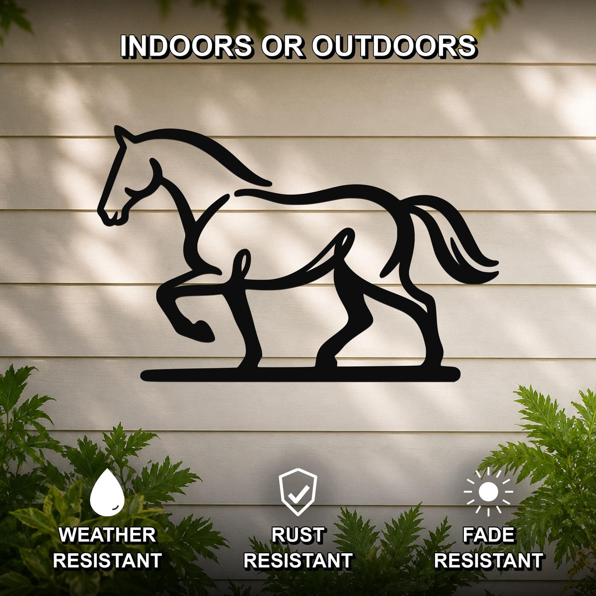 Black metal horse silhouette wall art with cutout details, mounted on a light-colored outdoor wall with greenery, weather, rust, and fade resistant.