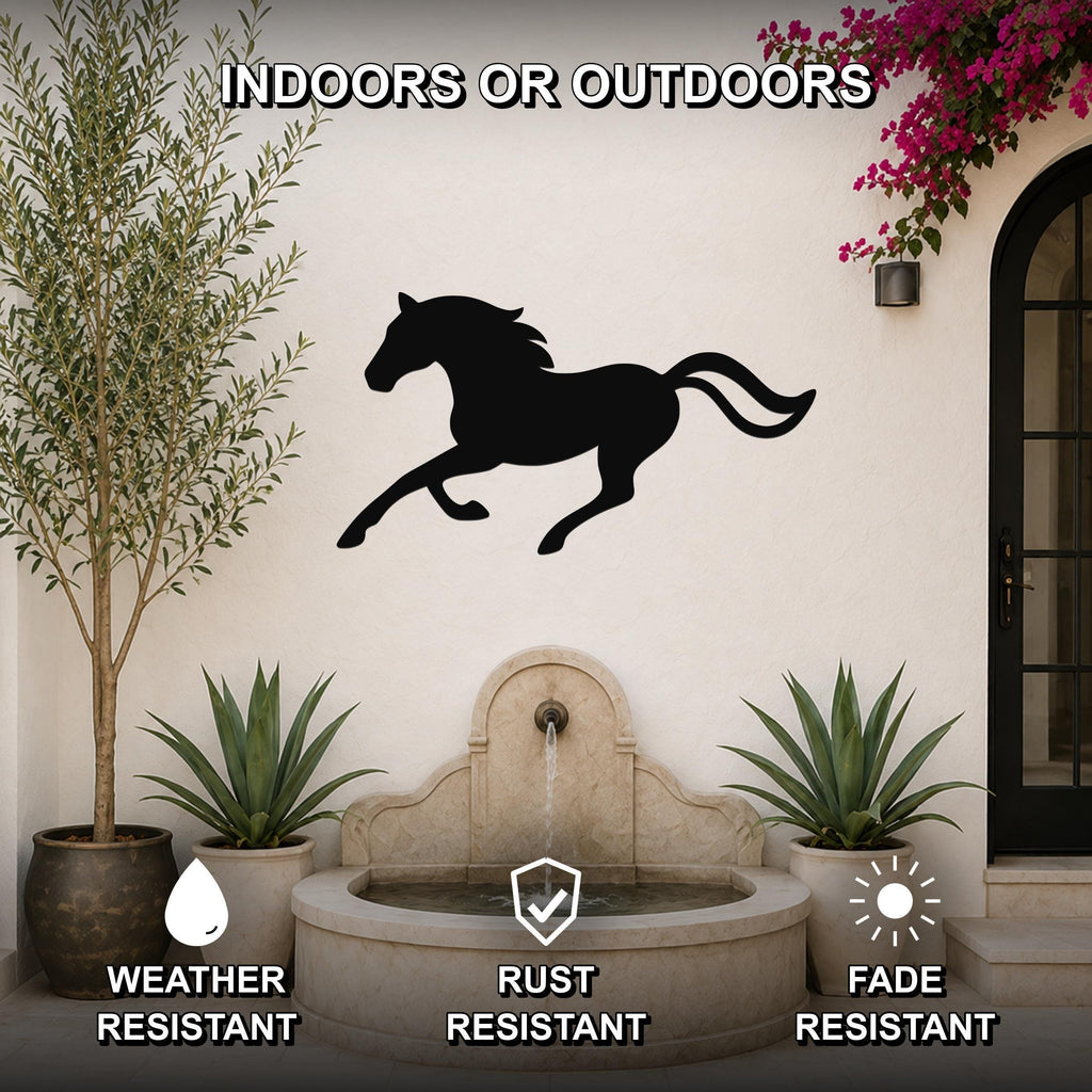 Black metal horse silhouette wall art mounted on an outdoor wall above a stone fountain, flanked by potted plants and a flowering vine.