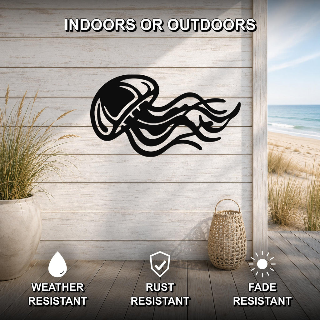 Black metal jellyfish wall art with flowing tentacle cutouts, mounted on a light wood plank wall in a coastal indoor-outdoor space.