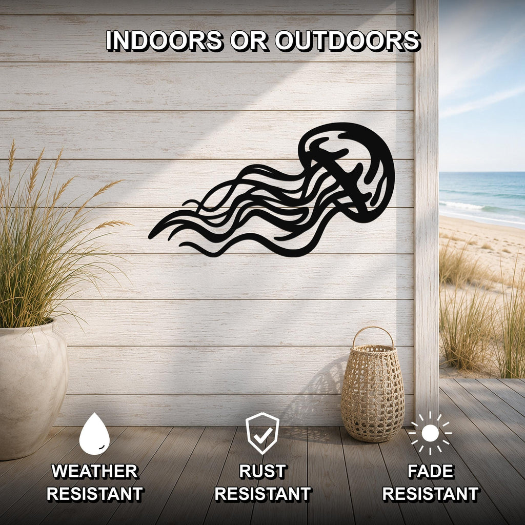 Black metal jellyfish wall art with flowing tentacle cutouts, mounted on a light wood plank wall above a deck with a beach view.