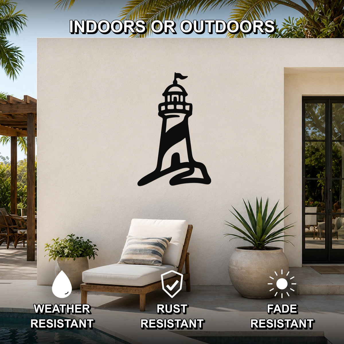 Black metal lighthouse wall art with a flag cutout, mounted on an outdoor patio wall above a lounge chair.