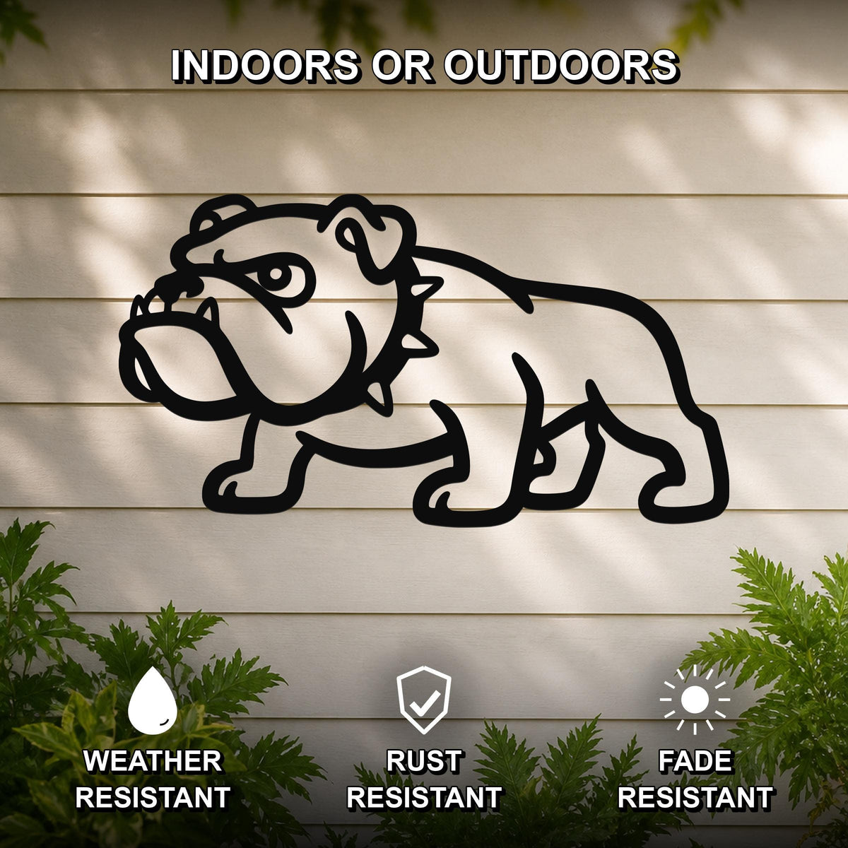 Black metal bulldog wall sculpture with bold silhouette, mounted on a light-colored outdoor wall with greenery, weather resistant, rust resistant, and fade resistant.