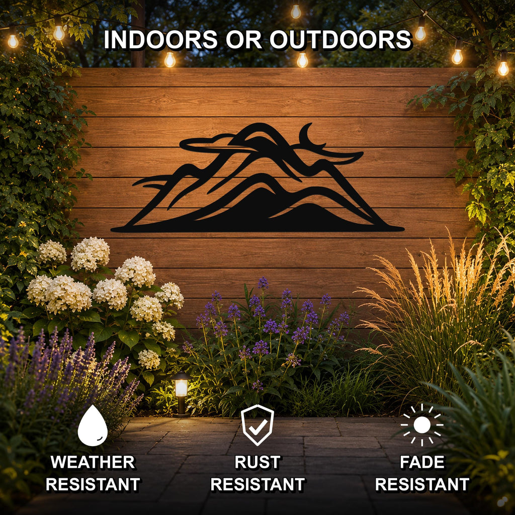 Black metal mountain silhouette wall art mounted on a wooden outdoor wall, surrounded by plants and string lights, with weather, rust, and fade resistant features.
