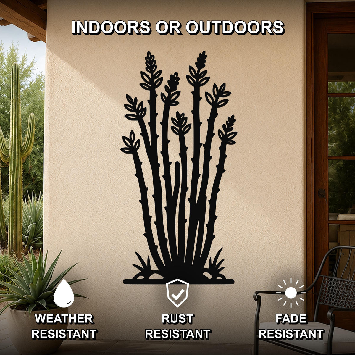 Black metal ocotillo wall art with leafy branch cutouts, mounted on an outdoor patio wall above a potted plant.
