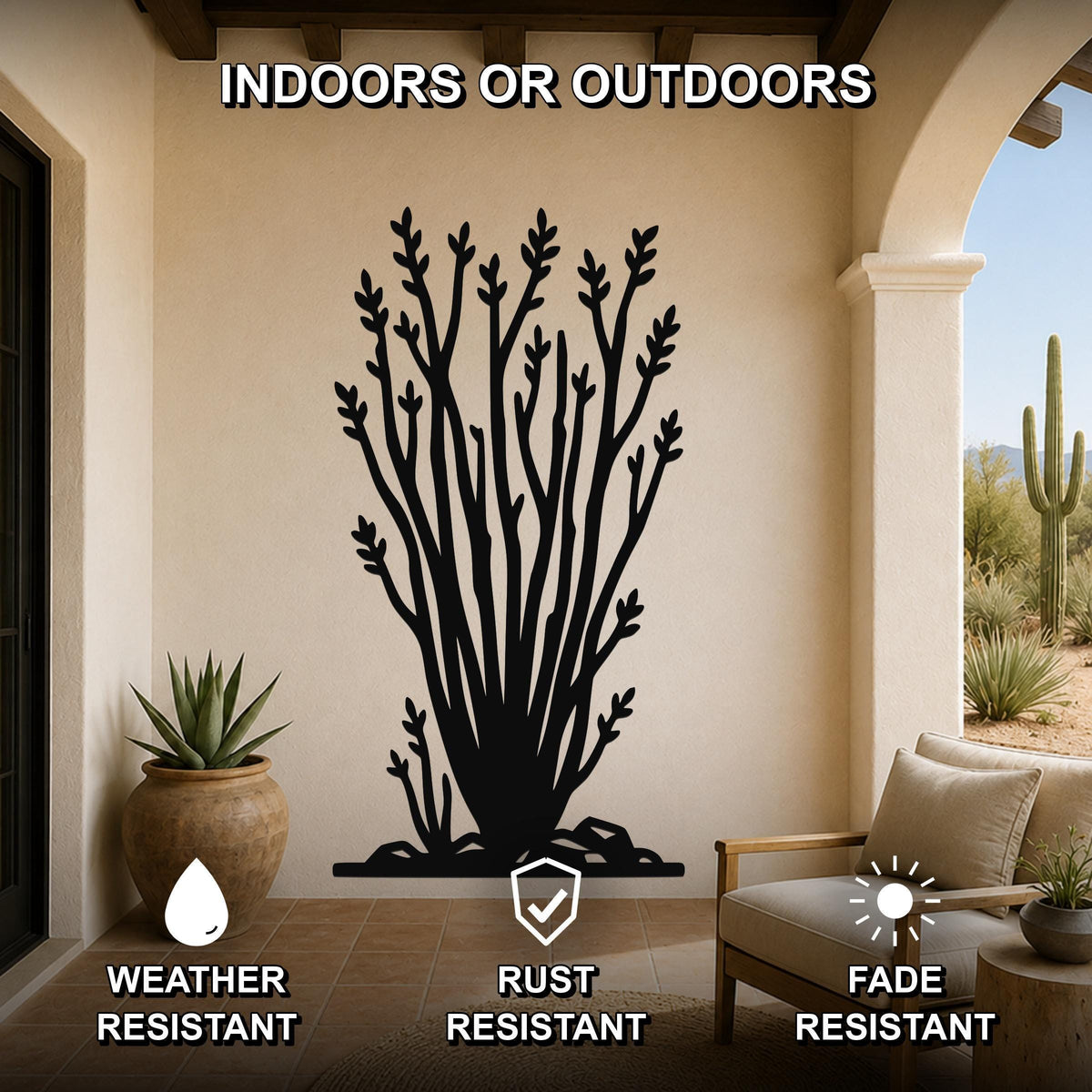 Black metal ocotillo wall art with branching cutouts, mounted on a beige patio wall above a chair, shown in an indoor-outdoor setting.