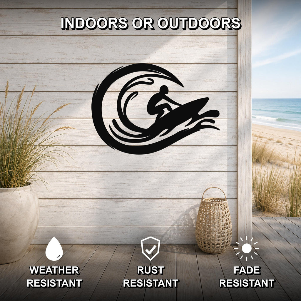 Black metal wall art featuring a surfer silhouette riding a wave, mounted on a light wood wall above a deck with a beach view, weather, rust, and fade resistant.