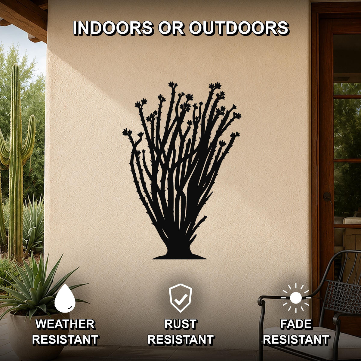 Black metal ocotillo wall art silhouette with branching stems and flower cutouts, mounted on an outdoor patio wall above a potted plant.