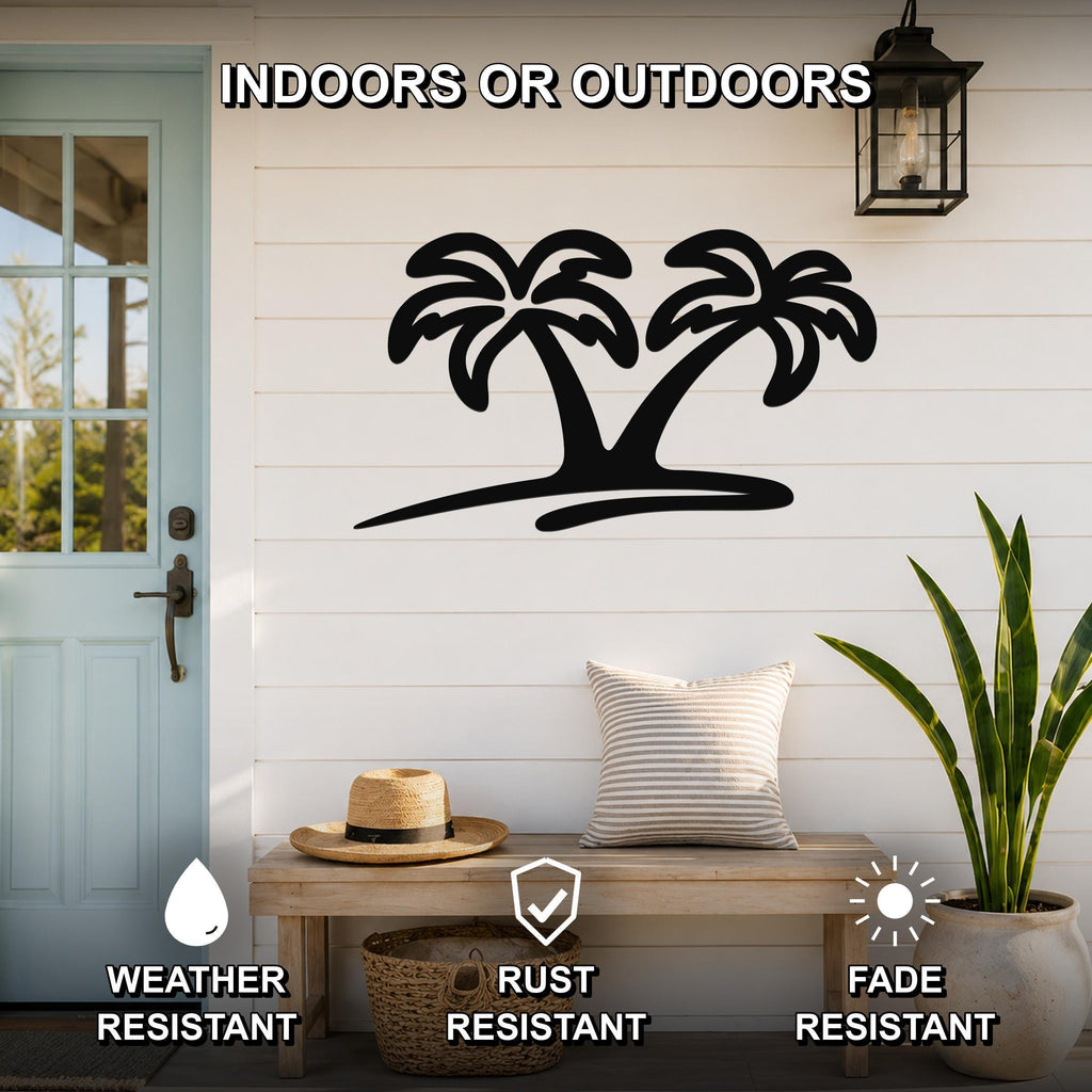Black metal palm tree wall art with two silhouetted trees, mounted on a white shiplap wall above a wooden bench on a porch.