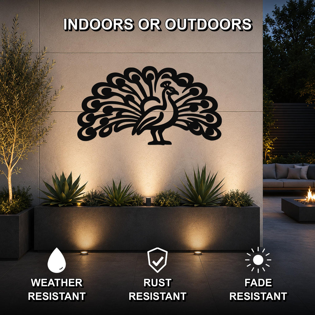Black metal peacock wall art with intricate feather cutouts, mounted on an outdoor wall above a planter in a modern patio setting.