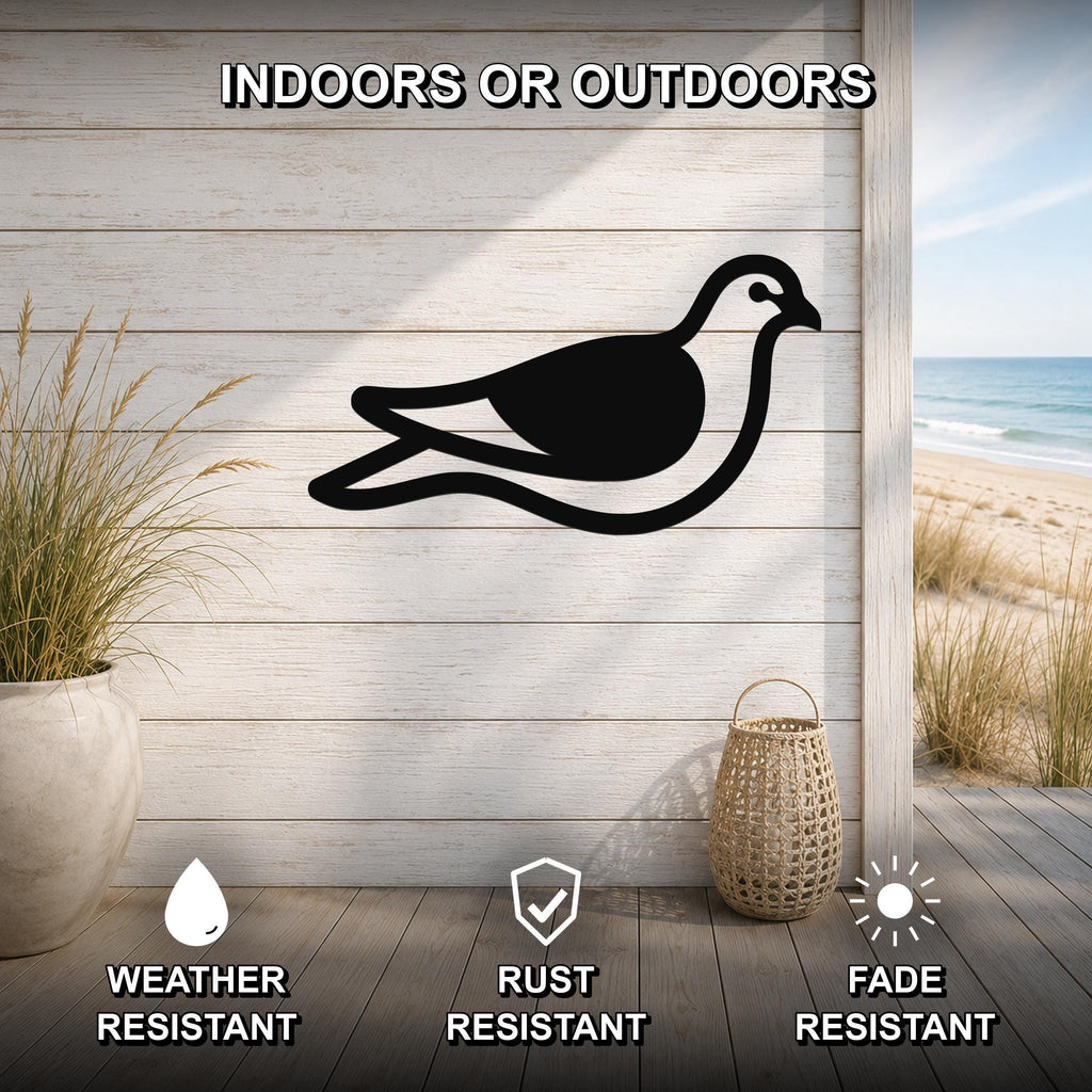 Black metal pigeon wall art silhouette mounted on a light wood plank wall, displayed on a patio with a beach view, weather resistant, rust resistant, and fade resistant.