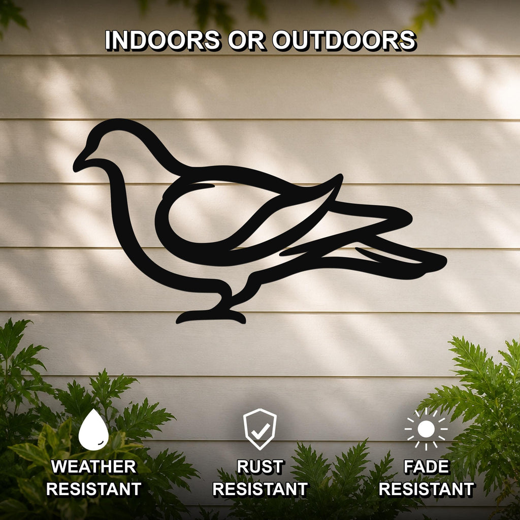 Black metal pigeon wall art silhouette with cutout design, mounted on a light-colored outdoor wall with greenery below.