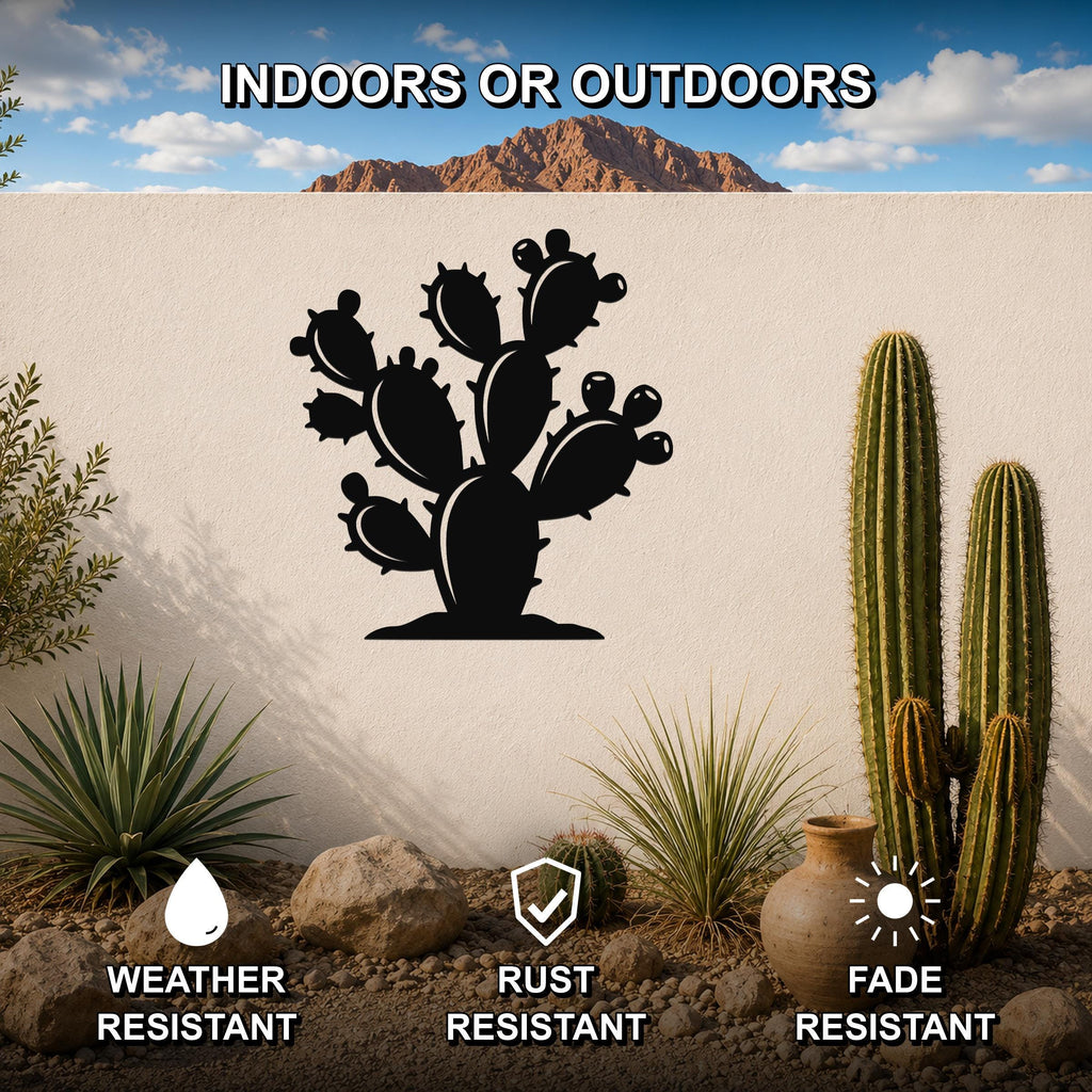 Black metal prickly pear cactus wall art with detailed cutout silhouette, mounted on an outdoor wall in a desert garden setting.