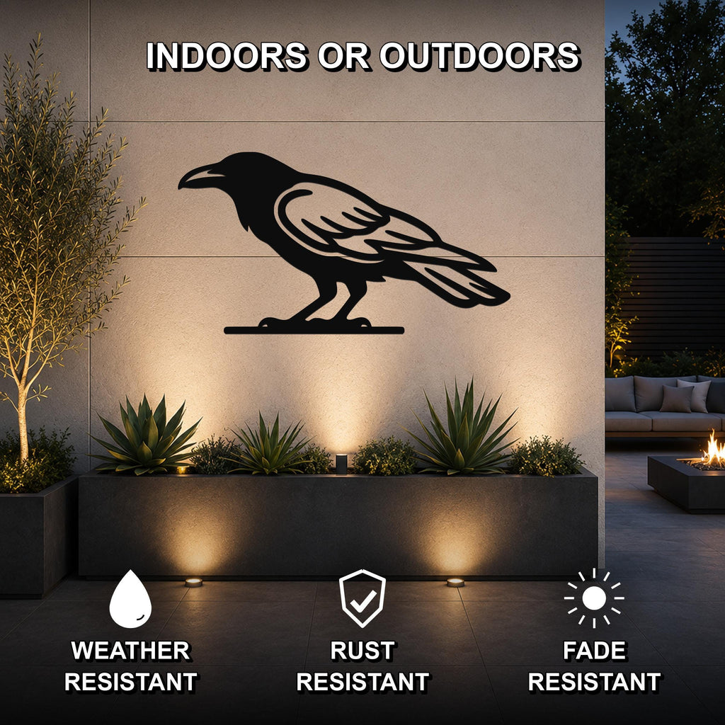 Black metal raven wall art silhouette mounted on an outdoor wall above a planter, with text indicating it is weather, rust, and fade resistant for indoor or outdoor use.