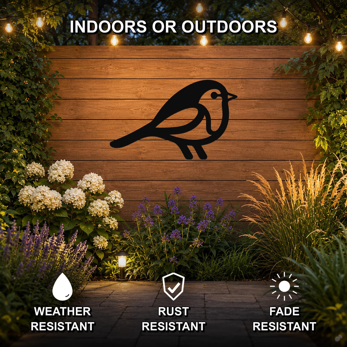 Black metal robin wall art silhouette mounted on a wooden outdoor wall, surrounded by garden plants and string lights, with text indicating it is weather, rust, and fade resistant.