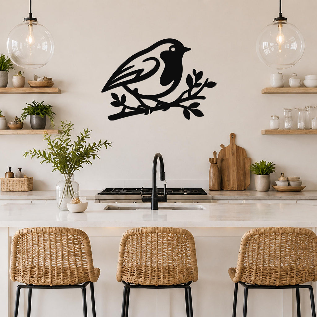 Black metal robin wall art silhouette perched on a branch, mounted above a kitchen counter with wicker stools and open shelving.
