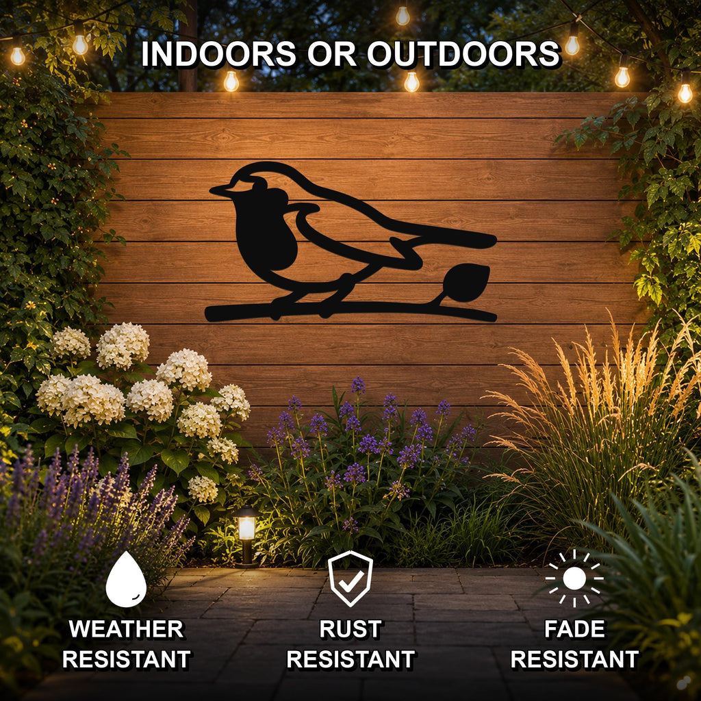 Black metal robin wall art silhouette perched on a branch, mounted on a wooden outdoor wall with string lights and garden plants, weather resistant, rust resistant, fade resistant.