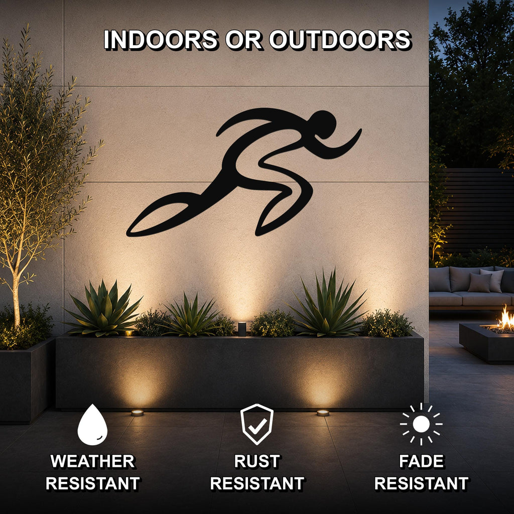 Black metal runner wall art with motion-line cutouts, mounted on an outdoor wall above a planter in a modern patio setting.