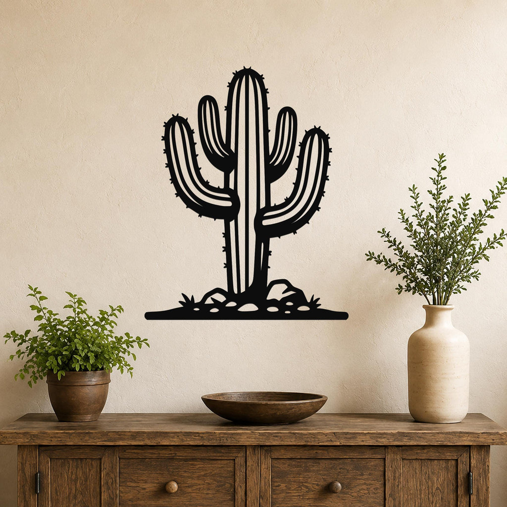 Black metal wall art in the silhouette of a saguaro cactus with spines and side arms, mounted on a wall above a wooden console table.