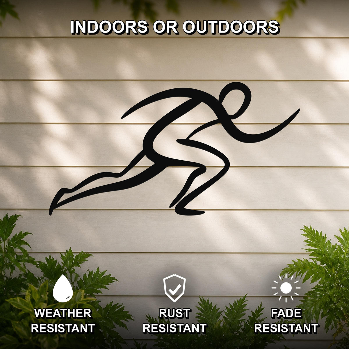 Black metal runner wall art with motion-line cutouts, mounted on a light-colored outdoor wall above green plants.