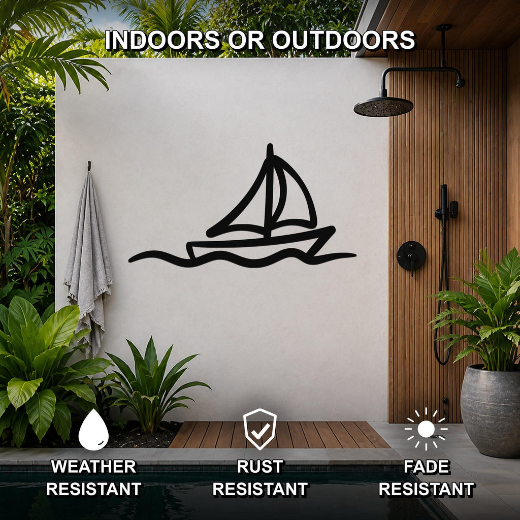 Black metal sailboat wall art with wave cutouts, mounted on a white outdoor shower wall beside a wooden panel and pool.