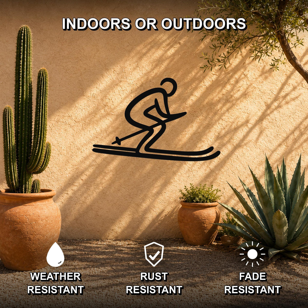 Black metal skiing silhouette wall art with a dynamic skier cutout, mounted on an outdoor stucco wall among potted cacti and succulents.