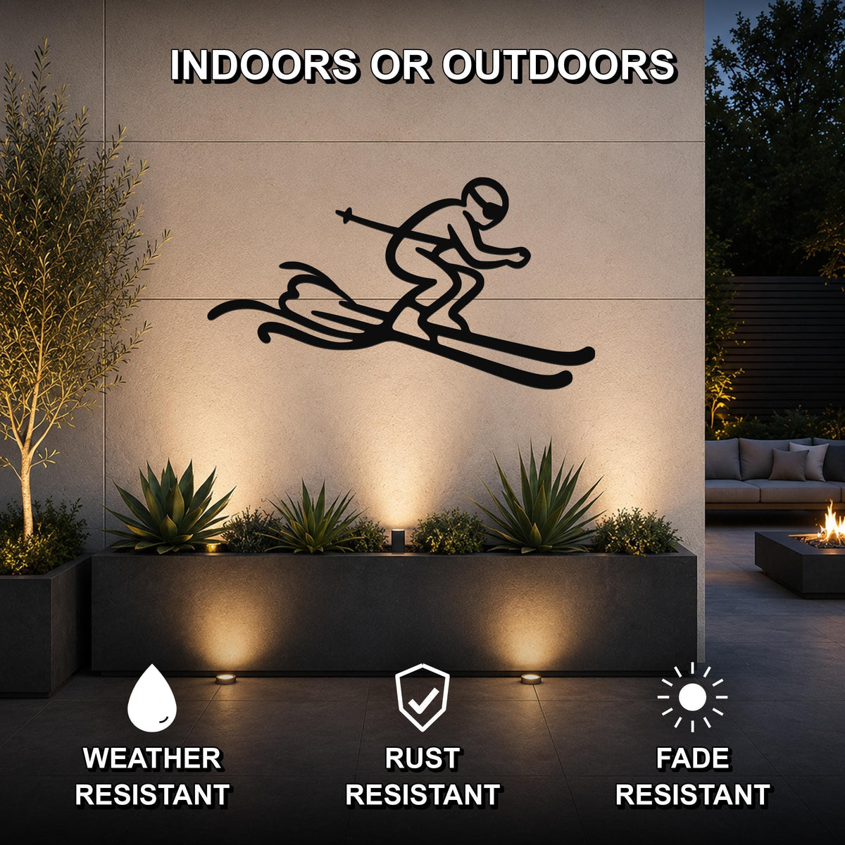 Black metal skier silhouette wall art with motion lines, mounted on an outdoor wall above a planter in a modern patio setting.