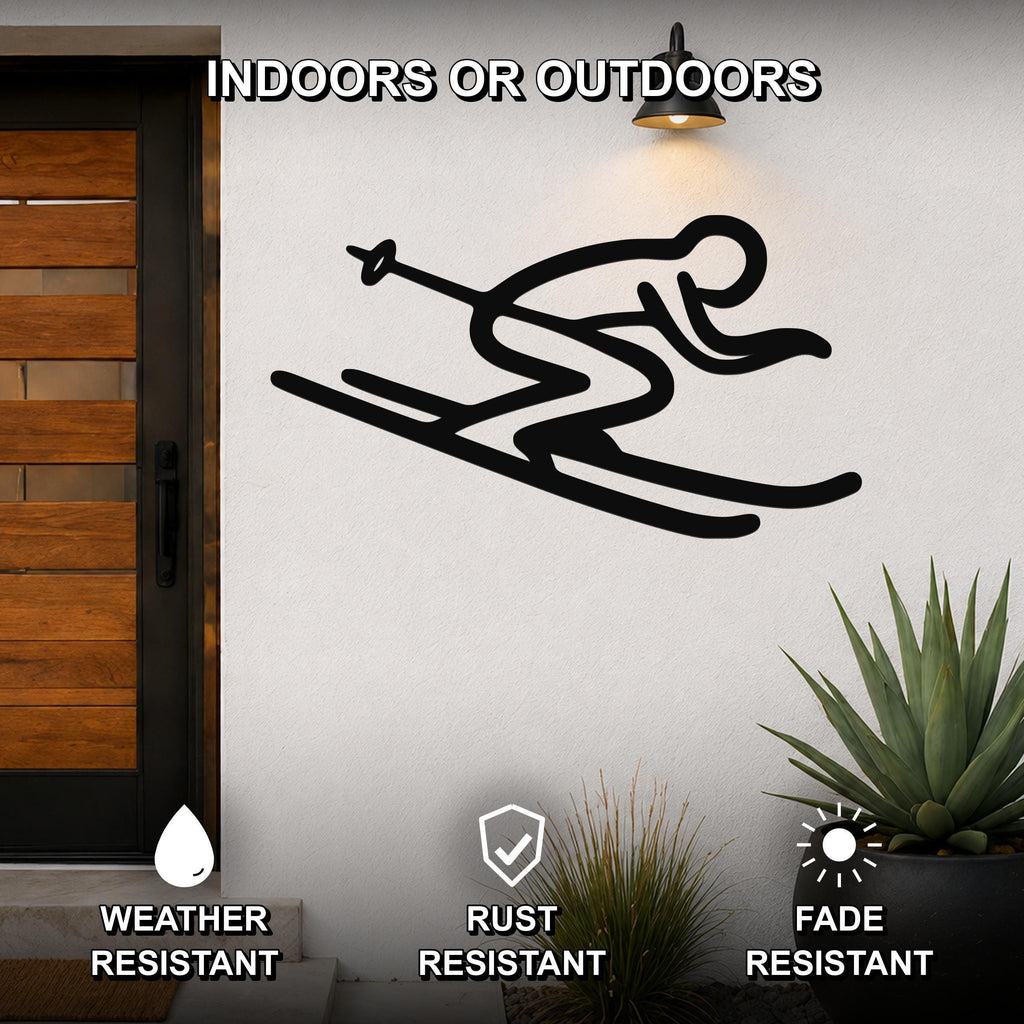 Black metal skiing wall art with a minimalist silhouette of a skier in motion, mounted on an outdoor wall beside a wooden door and potted plants.